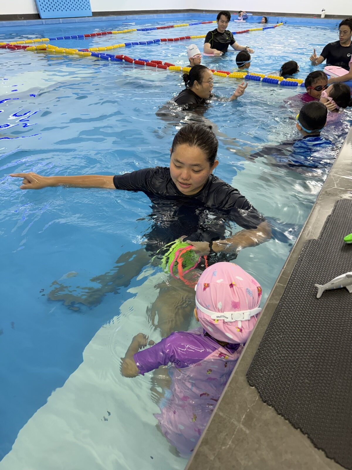 Baby swimming class at Skywhale Puchong Jaya — coach guiding toddler in 32°C heated pool