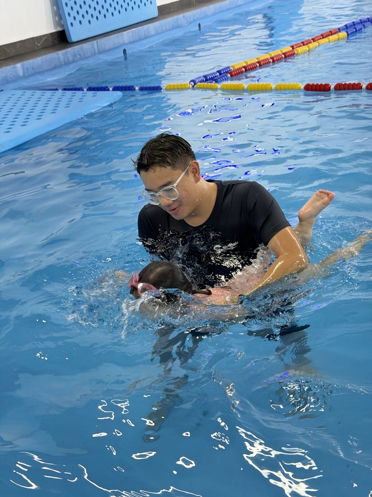 Kiddie swimming class — coach supporting a young child, Puchong Jaya